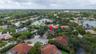 Aerial perspective of a property featuring a cul-de-sac location, tile roofing, and mature perimeter landscaping