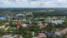 Aerial perspective showcasing a residential property with a tiled roof and a private swimming pool located on a landscaped lot