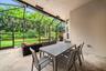 Screened-in lanai featuring stone-finish flooring, recessed lighting, and a metal enclosure