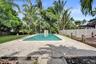 Full-size pool anchors the expansive backyard, rare space for the island