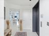 Entry foyer featuring high-gloss tile flooring, a dedicated elevator access point, and recessed ceiling lighting