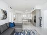 Kitchen featuring wood-finish cabinetry, built-in wall oven, and smooth surface flooring