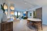 Herringbone wood-finish flooring, floor-to-ceiling glass balcony doors, decorative tiered pendant lighting, vertical wood slat wall detailing, and adj