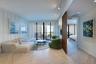 Herringbone-patterned wood-finish flooring, floor-to-ceiling glass doors, decorative vertical slat room divider, recessed track lighting, and board-an