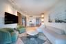 Vertical wall paneling, track lighting, herringbone-patterned wood-finish flooring, and multi-tiered decorative pendant lighting