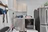 Laundry area featuring wall-mounted upper cabinetry and stainless steel appliance hookups