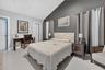 Vaulted ceiling with recessed lighting, large-format tile flooring, and a contrast accent wall