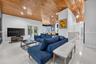 Vaulted wood-plank ceiling, recessed lighting, white tile flooring, and glass-paned double doors