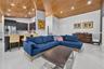 Vaulted tongue-and-groove wood ceiling featuring recessed lighting, polished porcelain tile flooring, and dark-toned cabinetry with integrated wine st