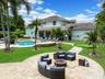 Backyard featuring a custom swimming pool, integrated spa, putting green, and stone-paver patio area