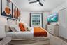 Vaulted ceiling featuring a central multi-blade ceiling fan, louvered closet doors, and horizontal window blinds