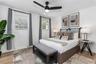 Wood-finish flooring, matte black ceiling fan with integrated lighting, and dual shutter-style windows