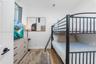 Neutral interior space featuring wood-finish flooring, white walls, and a recessed ceiling lighting fixture