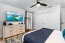 Interior space featuring wood-finish flooring, a ceiling fan with integrated lighting, and white paneled bi-fold closet doors