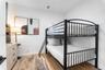 Bedroom featuring wood-finish flooring and neutral wall color