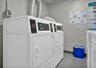 Dedicated laundry area featuring dual commercial-grade dryers on each floor.
