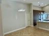 Vaulted ceilings featuring modern sculptural pendant lighting, stone-finish tile flooring, floor-to-ceiling wood-finish cabinetry, and recessed lighti