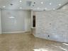 Stacked stone accent wall, recessed lighting, polished tile flooring, skylight, and modern pendant lighting