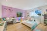 Spacious room featuring light-toned wood-finish flooring, recessed lighting, and multi-pane windows