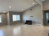 Vaulted ceilings featuring recessed lighting, large grid-style windows, and neutral-tone tile flooring