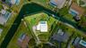 Waterfront parcel featuring a corner lot orientation, an inground swimming pool, and mature perimeter landscaping