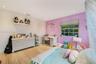 Bedroom featuring wood-finish flooring, recessed lighting, and a built-in floating wall shelf