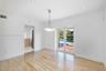 Light-filled room featuring wood-finish flooring, recessed lighting, a modern multi-light chandelier, and glass-paned double doors with access to an e