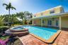 Exterior living area featuring a covered patio, rectangular swimming pool with an integrated spa, and terra-cotta tile decking