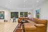 Light-toned wood-finish flooring, recessed lighting, and grid-pattern windows