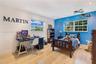 Room featuring wood-finish flooring, recessed lighting, and multiple windows with muntin detailing