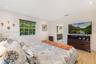 Room featuring recessed lighting, wood-finish flooring, and a multi-pane window