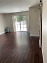 Wood-finish flooring, sliding glass patio door with muntins, recessed ceiling lighting, and a mounted rustic-style sliding barn door