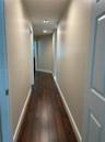 Hallway featuring wood-finish flooring, recessed lighting, and neutral wall paint