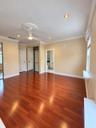 Wood-finish flooring, recessed lighting, crown molding, ceiling fan with decorative medallion, and mirrored sliding closet doors