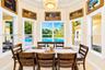 Octagonal breakfast area featuring a tray ceiling, recessed center light fixture, tile flooring, and oversized windows