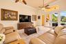Vaulted ceilings, large-format tile flooring, dual ceiling fans, crown molding, and glass double doors providing access to the exterior