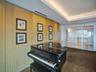 Wall-to-ceiling wood paneling, recessed cove lighting, and floor-to-ceiling glass panel doors