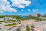 Elevated perspective of the surrounding urban landscape, waterfront proximity, and expansive sky