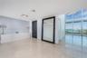 Floor-to-ceiling windows, stone flooring, built-in cabinetry, and neutral-toned wall finish