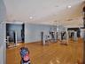 Fitness area featuring wood-finish flooring, recessed lighting, and expansive wall-to-wall mirrors
