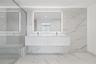 Double floating vanity with white cabinetry, rectangular vessel sinks, wall-to-wall rectified tile surfacing, backlit mirror, and glass-enclosed showe