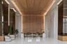Grand lobby featuring a geometric wood-paneled ceiling and feature wall with integrated cove lighting, polished stone flooring, and mirrored structura