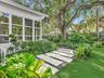 Landscaped gated yard with turf and built in bar for bbq