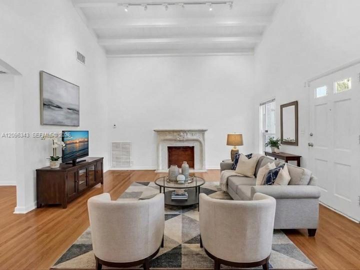Virtually Staged. Awesome living room with high ceilings and exposed beams. Great home for rent in Coconut Grove in Miami, FL. Enjoy large fenced yard
