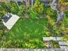 Landscaped gated yard with turf and built in bar for bbq in home for rent in Coconut Grove in Miami, FL. Enjoy this updated home in the North Grove. N