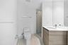 Modern bathroom featuring a floating wood-finish vanity with an integrated sink and chrome faucet, white quartz countertop, large mirror with integrat