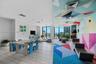 Large interior space featuring wood-finish flooring, floor-to-ceiling windows, and recessed lighting