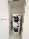 Stacked washer and dryer unit housed in a dedicated closet space