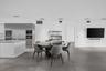 Open-concept space featuring large-format tile flooring, stainless steel integrated appliance suite, built-in shelving, and recessed ceiling lighting