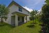 Two-story exterior featuring a covered patio, paved hardscaping, and landscaped green space